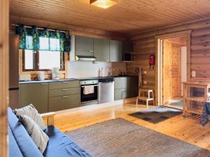 a kitchen with a blue couch in a room at Villa Hauki, Puruvesi Lakeside by Naaranlahti in Naaranlahti +15 photos