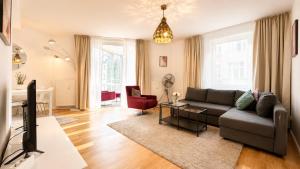 a living room with a couch and a table at URBAN FLATS Berlin in Berlin