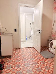 a bathroom with a shower and a toilet and a door at Уютный дом GS in Kegeti +14 photos