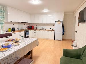 a kitchen with a table with food on it at Уютный дом GS in Kegeti