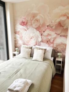a bedroom with a flower mural on the wall at Roztoczańska Stodoła in Majdan Sopocki +18 photos