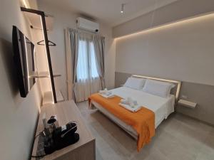 a bedroom with a bed with two towels on it at Acqua Marina Rooms in La Caletta