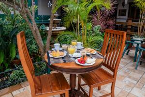 a wooden table with food and drinks on it at Tiradentes Village in Tiradentes