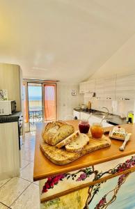 a kitchen with a table with some bread on it at Grandmother's Attic in Furore