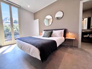 a bedroom with a large bed with two mirrors at My Residence d'Azur in Beausoleil