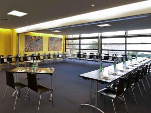 a large room with tables and chairs in it at ibis Styles Ouistreham in Ouistreham