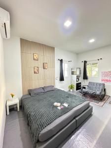 a bedroom with a large bed and a couch at Summer Sunshine in Songkhla