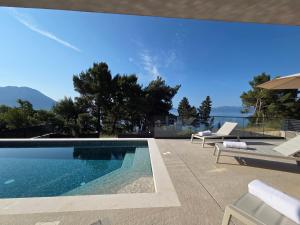 a swimming pool in a villa with a view at Villa Tedi in Podaca
