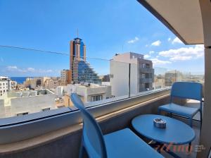 a balcony with a view of a city skyline at A Plus Hotel St Julians - Adults Only in St. Julianʼs