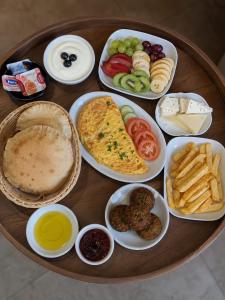 a table with plates of food on a table at Nile View Plaza Hotel in Cairo
