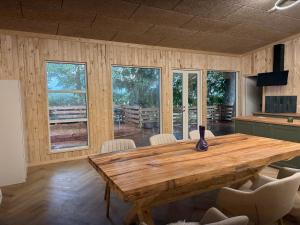 a dining room with a wooden table and chairs at Bornholm Eco Suites in Klemensker +7 photos