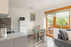 a kitchen and a living room with a table at 3 Rivers Apartment in Radovljica +8 photos