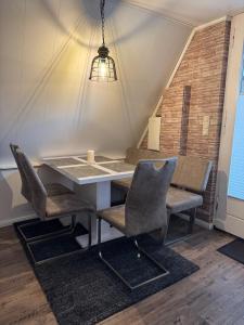 a dining room with a table and two chairs at Ferienhaus Conneforde in Wiefelstede +10 photos