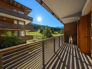 a balcony of a house with a dog standing on it at Hostdomus - Suite Les Etoiles in Sestriere