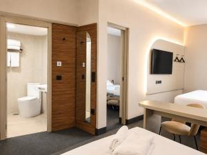 a hotel room with a bed and a bathroom at FORTINN Puerta del Sol in Madrid +57 photos
