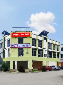 a hotel with a red sign on top of it at 1st Inn Hotel Klang Sentral Meru in Klang