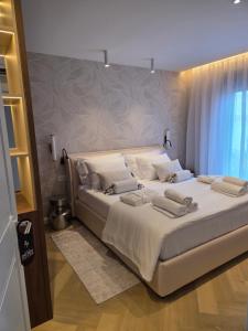 a bedroom with a large bed with white sheets and pillows at Villa Tedi in Podaca +77 photos