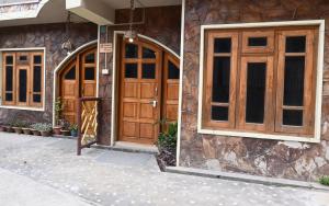 a building with wooden doors and windows at Quinton Enclave in Shillong