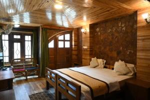 a bedroom with a bed in a room with wooden walls at Quinton Enclave in Shillong