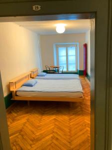 a bedroom with a bed with a table in it at Hotel Genossenschaft Kreuz in Solothurn