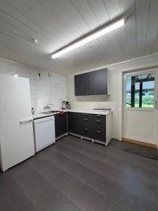a kitchen with white appliances and a white refrigerator at StarapApartment Odda 3 BR in Odda