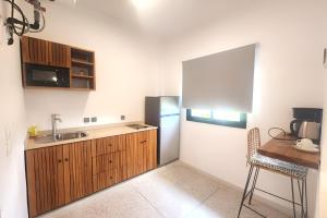 a kitchen with a stainless steel refrigerator and a table at Innoplaza Cocody in Abidjan