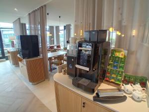 a store with a coffee machine on a counter at Radisson Hotel Berlin Charlottenburg in Berlin