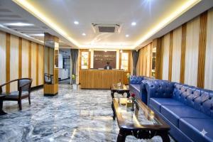 a lobby with a blue couch and a table at Hotel Tapowan - Near Tribhuvan International Airport in Kathmandu