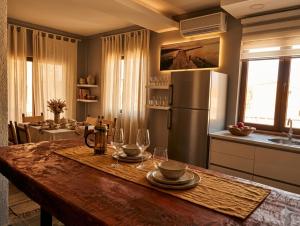 a kitchen with a wooden table with wine glasses on it at Loft in Kruce in Kruče