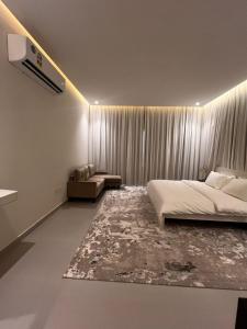 a bedroom with a bed and a rug at فيلا صلاله بالم salalah palm villa in Salalah +23 photos