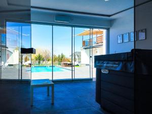 a living room with a view of a swimming pool at Banova Vendégház in Császártöltés