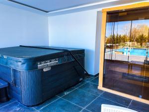 a large blue box sitting in a room with a pool at Banova Vendégház in Császártöltés