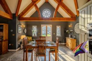 a dining room with a table and chairs at Cantre Selyf in Brecon