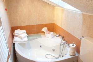 a bathroom with a bath tub and a sink at Hotel PIAN DEL SOLE Claviere in Claviere +38 photos
