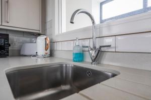 a stainless steel sink in a kitchen at Seaview apartment in Southbourne +40 photos