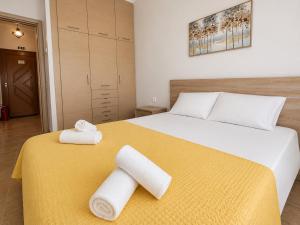 a bedroom with a bed with two towels on it at Otium Apartment in Nea Peramos