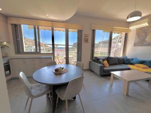 a living room with a table and a couch at elva creta beach in Palaiokastro