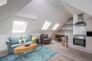a living room with a couch and a table at Seaview apartment in Southbourne