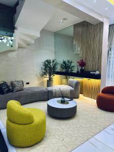 a living room with a couch and a table at Diah Homes Apartment in Benin City
