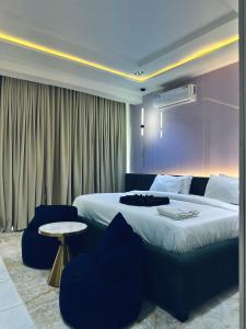 a bedroom with a large bed and a table at Diah Homes Apartment in Benin City