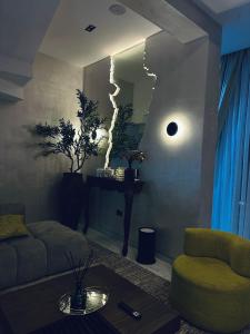 a living room with a couch and a mirror at Diah Homes Apartment in Benin City