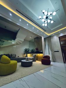 a living room with a couch and a table and chairs at Diah Homes Apartment in Benin City
