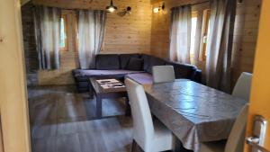 a living room with a couch and a table at Brvnare Libero TARA in Sekulić 
