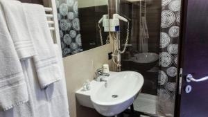 a bathroom with a white sink and a mirror at Albergo Miramonti in Gangi