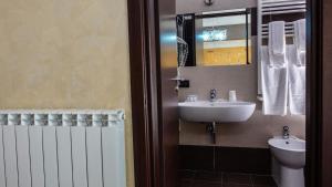 a bathroom with a sink and a mirror at Albergo Miramonti in Gangi