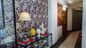 a room with a shelf with vases and a lamp at Albergo Miramonti in Gangi