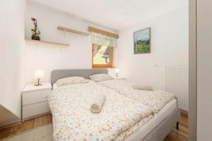 a bedroom with a bed and two night stands at 3 Rivers Apartment in Radovljica