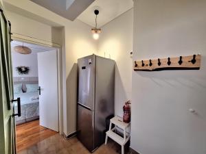 a kitchen with a stainless steel refrigerator in a room at The Handcrafted Haven 2 min to Central Square in Missolonghi +10 photos