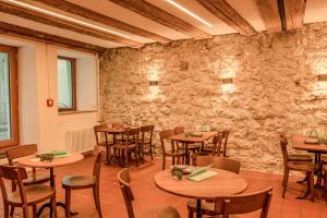 a restaurant with tables and chairs and a stone wall at Hotel Genossenschaft Kreuz in Solothurn