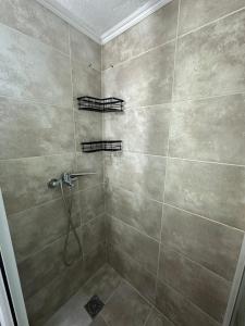 a bathroom with a shower with a large tiled shower at Otium Apartment in Nea Peramos +18 photos